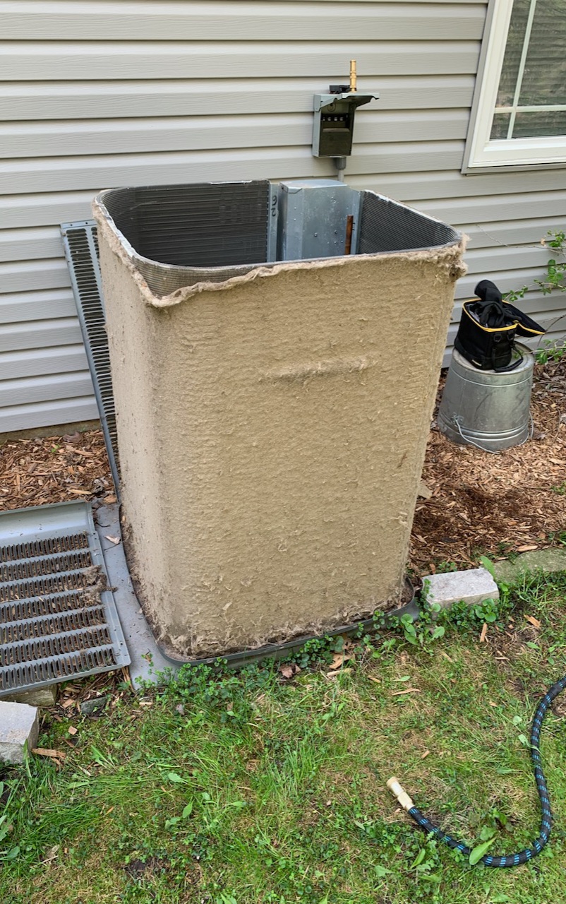 Dirty air conditioning unit with dust and debris accumulation, highlighting the need for regular maintenance to ensure efficient operation.
